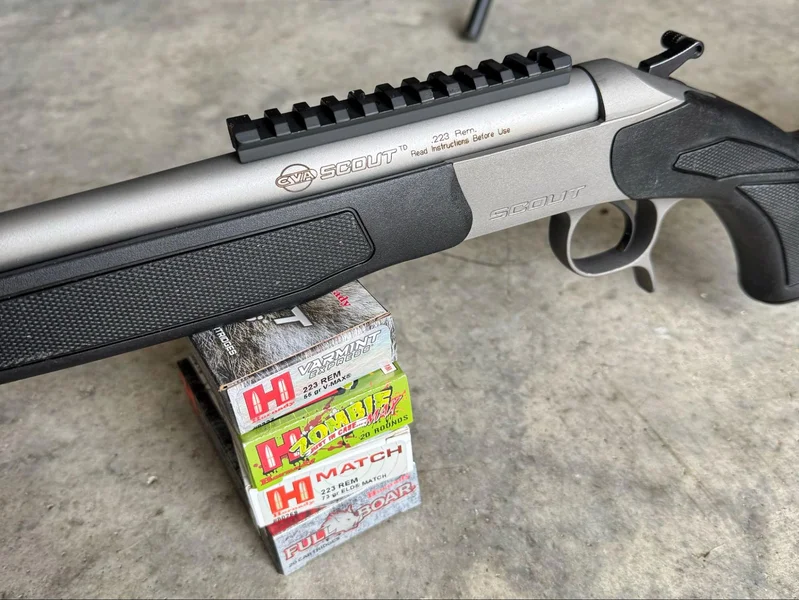CVA Scout TD rifle resting on boxes of Hornady .223 Remington ammunition including Match and Superformance loads