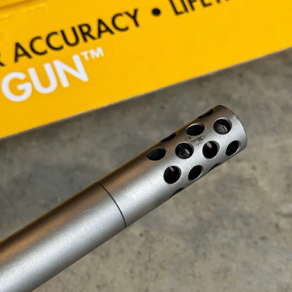 Detailed view of the muzzle brake on the 20-inch fluted and threaded barrel of the CVA Scout TD