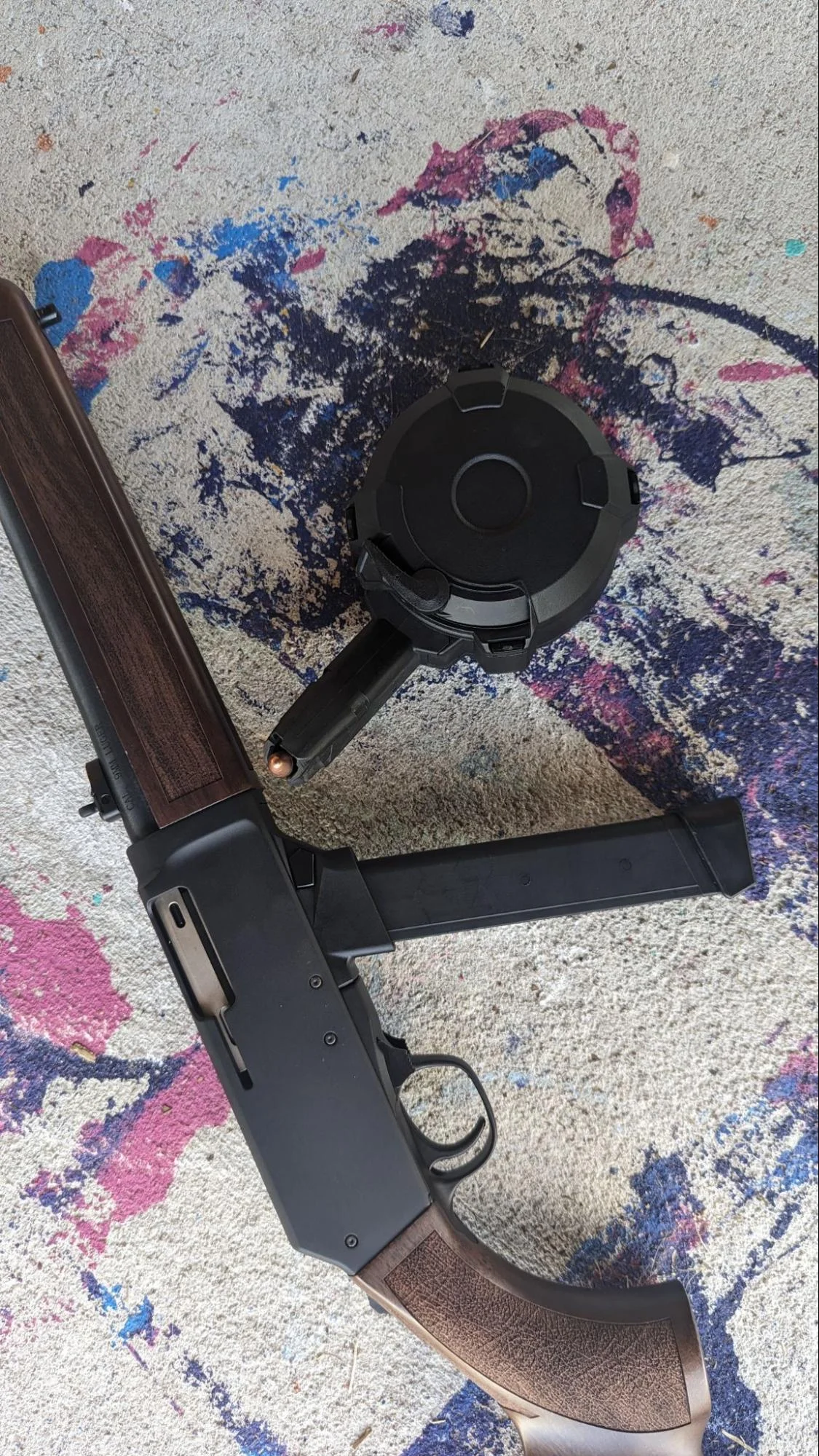 henry homesteader 9mm carbine on floor with paint background