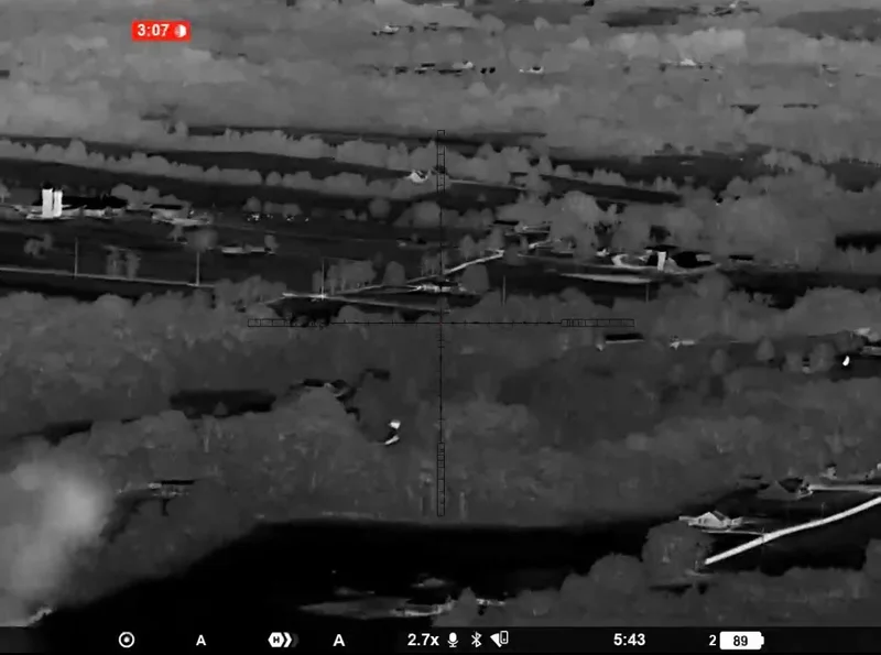 Night view at 2.7x of a populated valley: houses, roads, trees, and fields as heat
