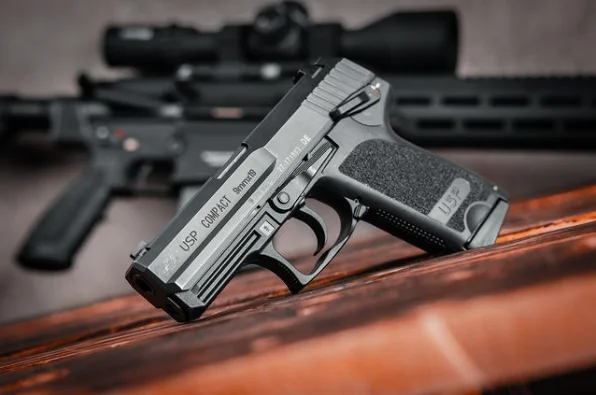 Heckler & Koch USP leaning on wood table