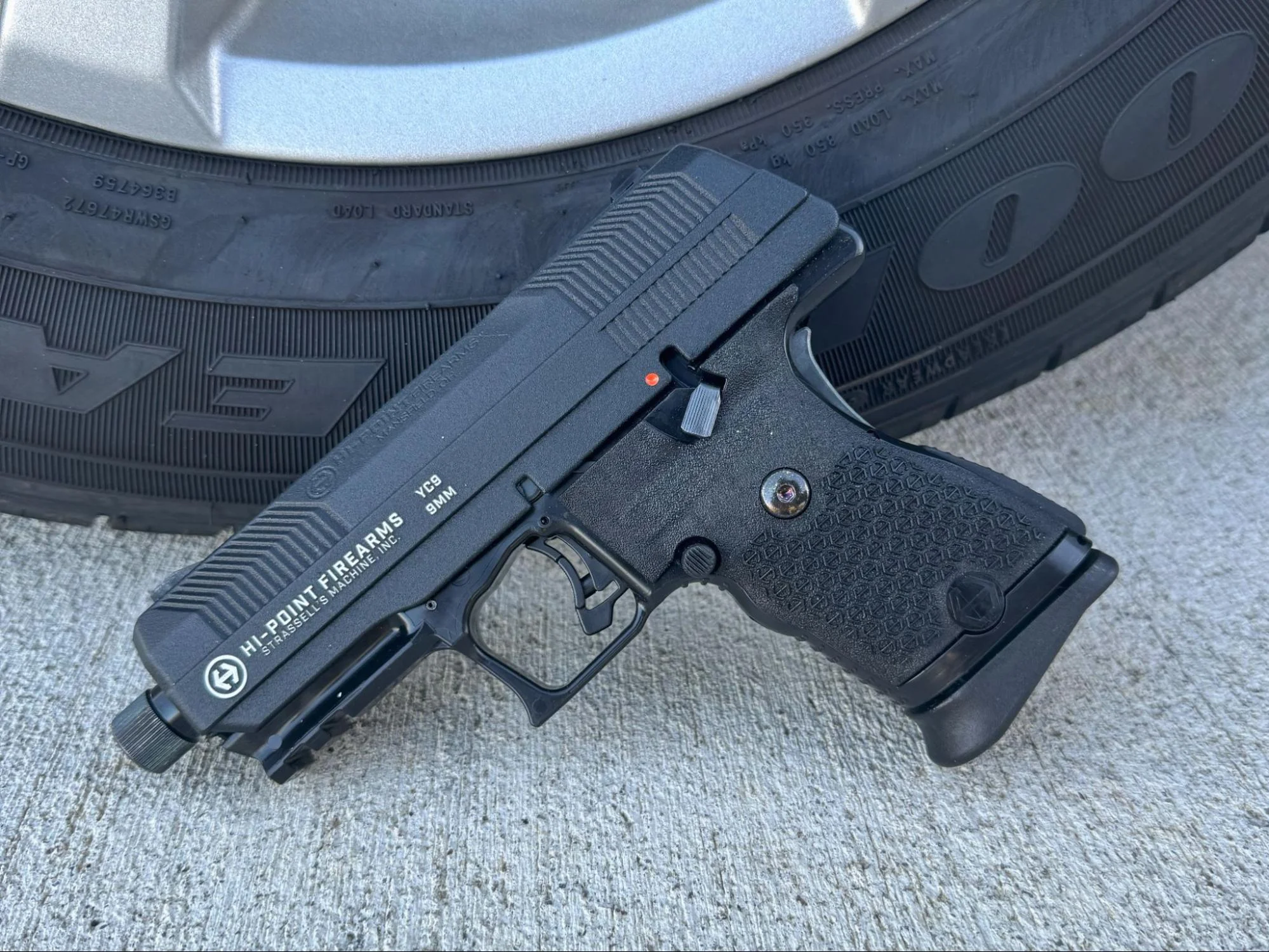 Hi-Point YC9 YEET Cannon leaned against truck tire