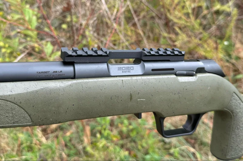 The Model 2020 Rimfire rifle with an interrupted Picatinny rail, illustrating the mount’s unique design for attaching various optics