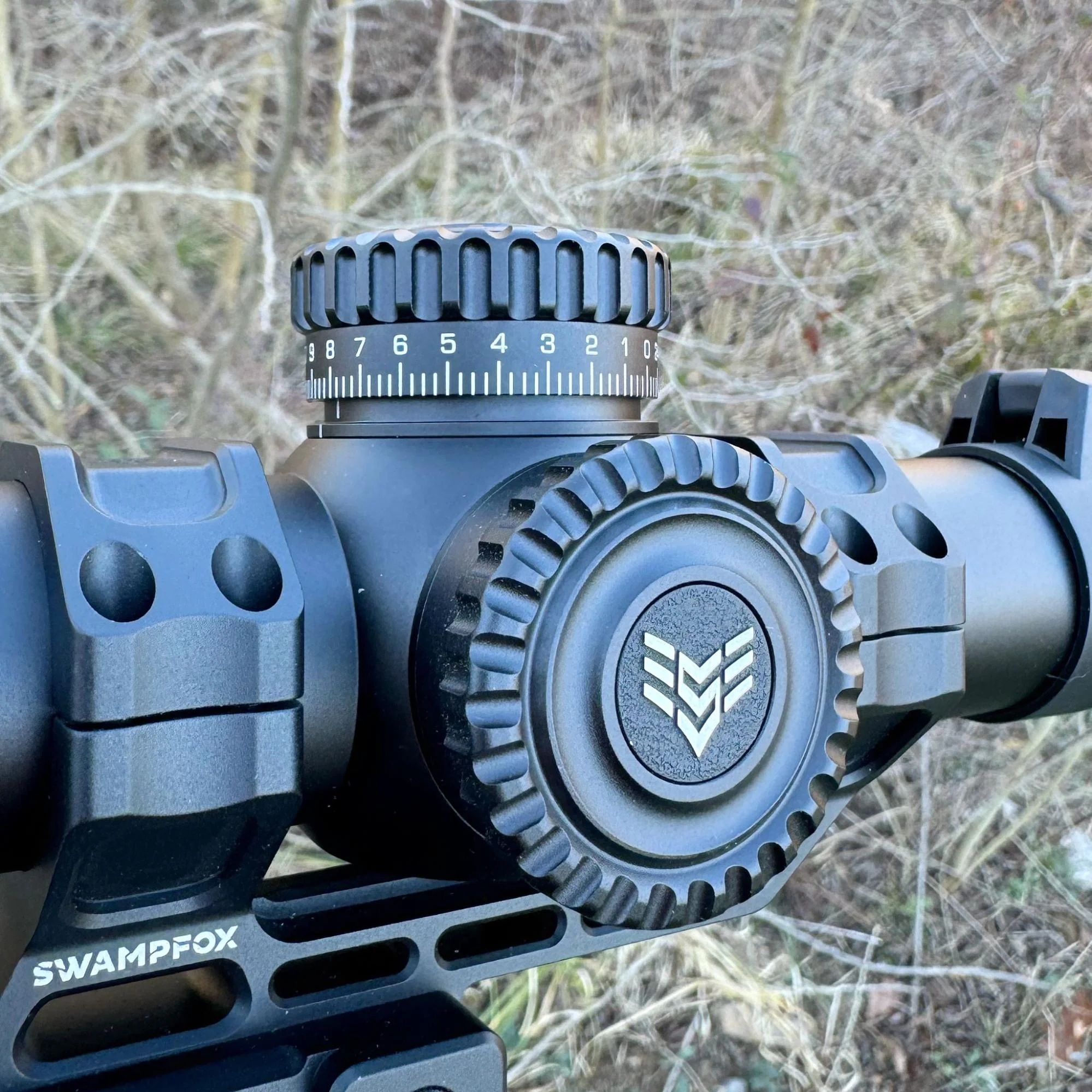 Close-up photo highlighting the elevation adjustment turret of the Swampfox Warhorse LPVO, emphasizing the tactile and audible clicks during adjustments