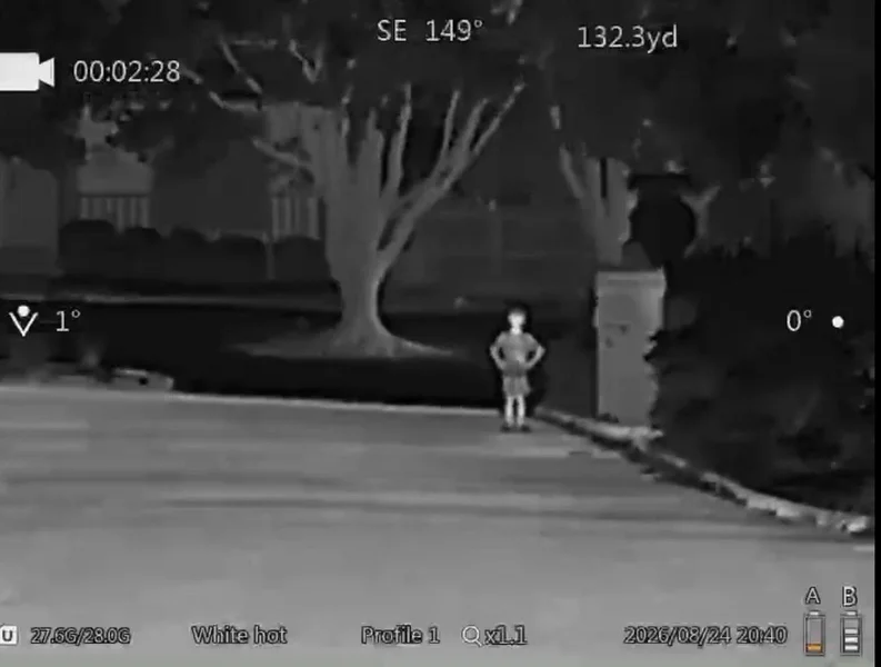 Goyojo GRS225RF rangefinder reading 132.3 yards on a boy standing near the curb