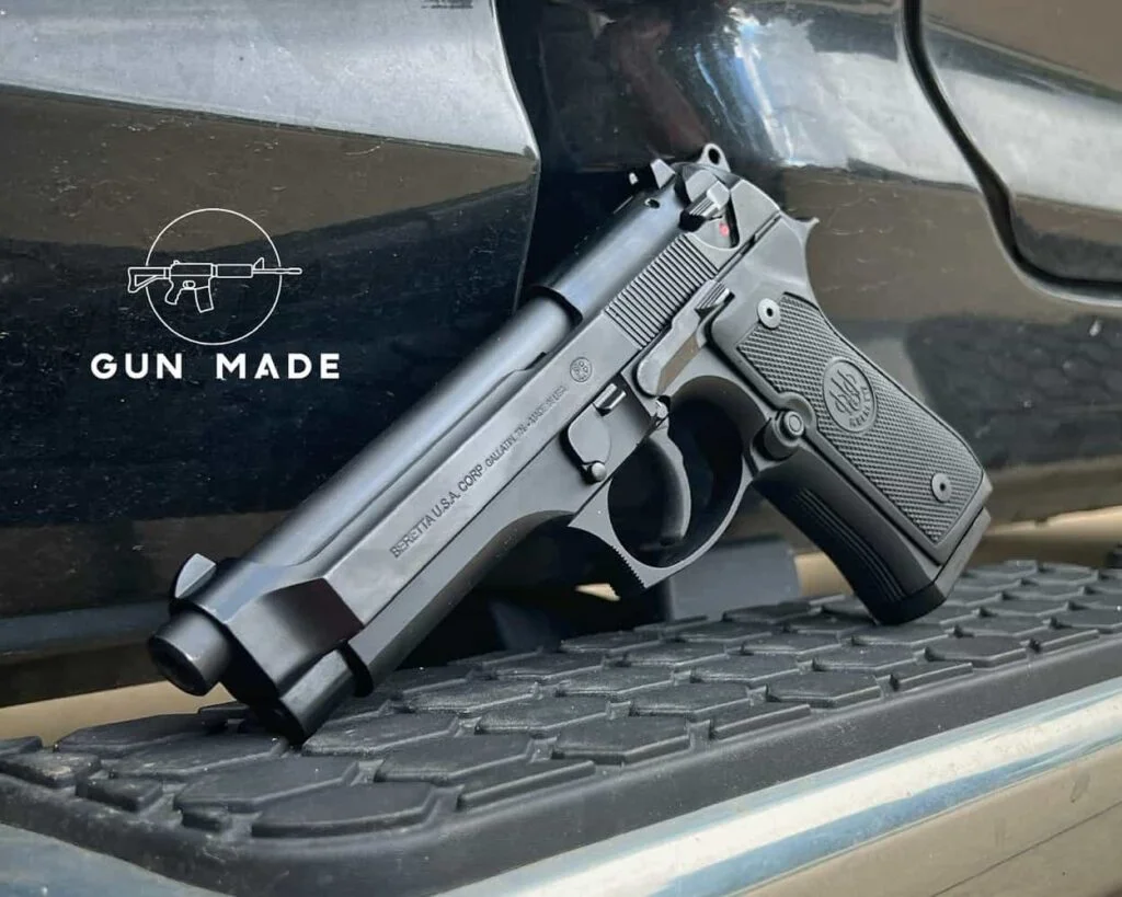 beretta 92fs propped up against truck