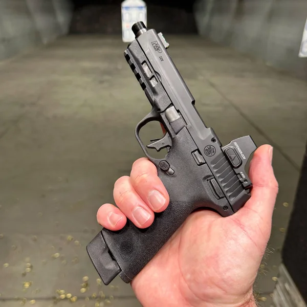 Shooter holding the Smith & Wesson M&P22X pistol showing the full-size tall grip texturing