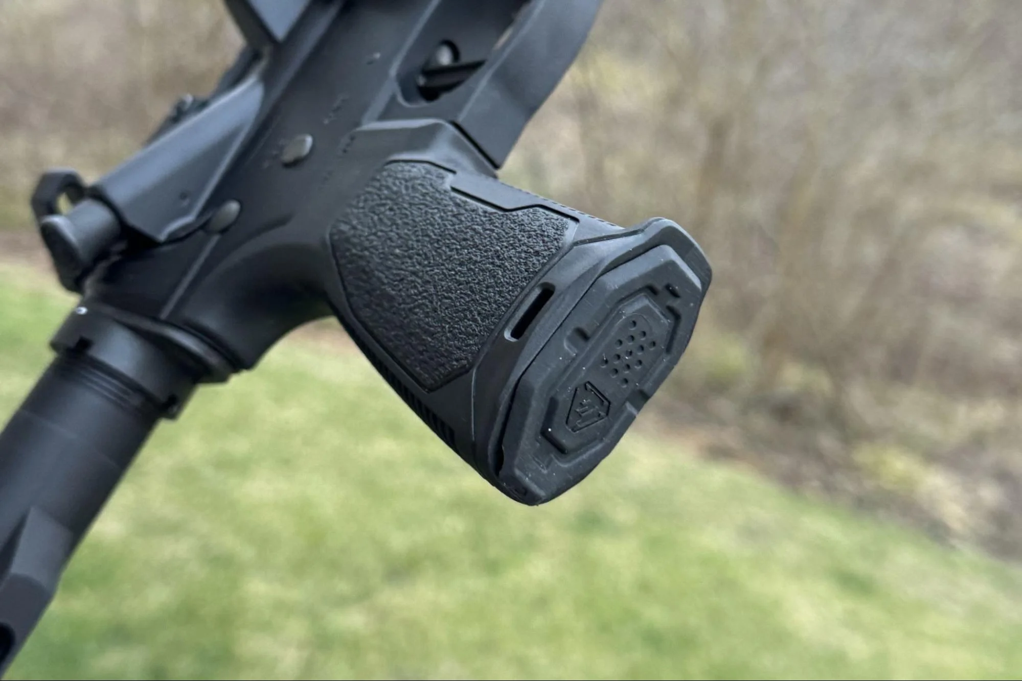 A photo illustrating various AR-15 grips, each featuring a different type of internal storage mechanism such as a plug or latch, to highlight this useful feature
