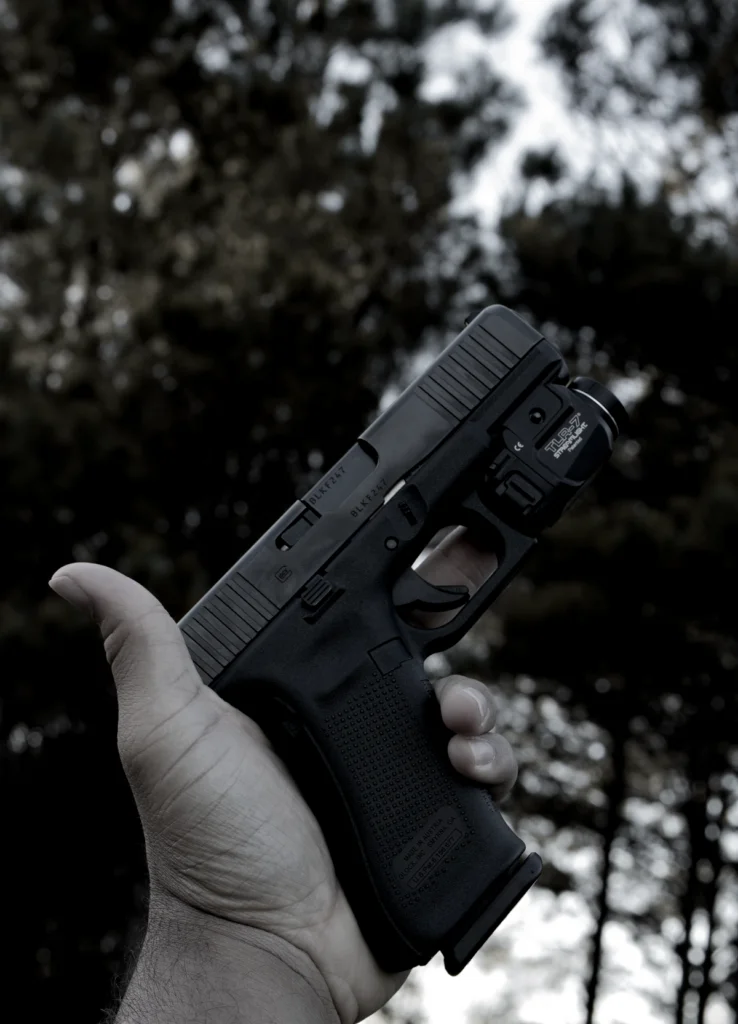 Man holding pistol. Glock gun in left hand.