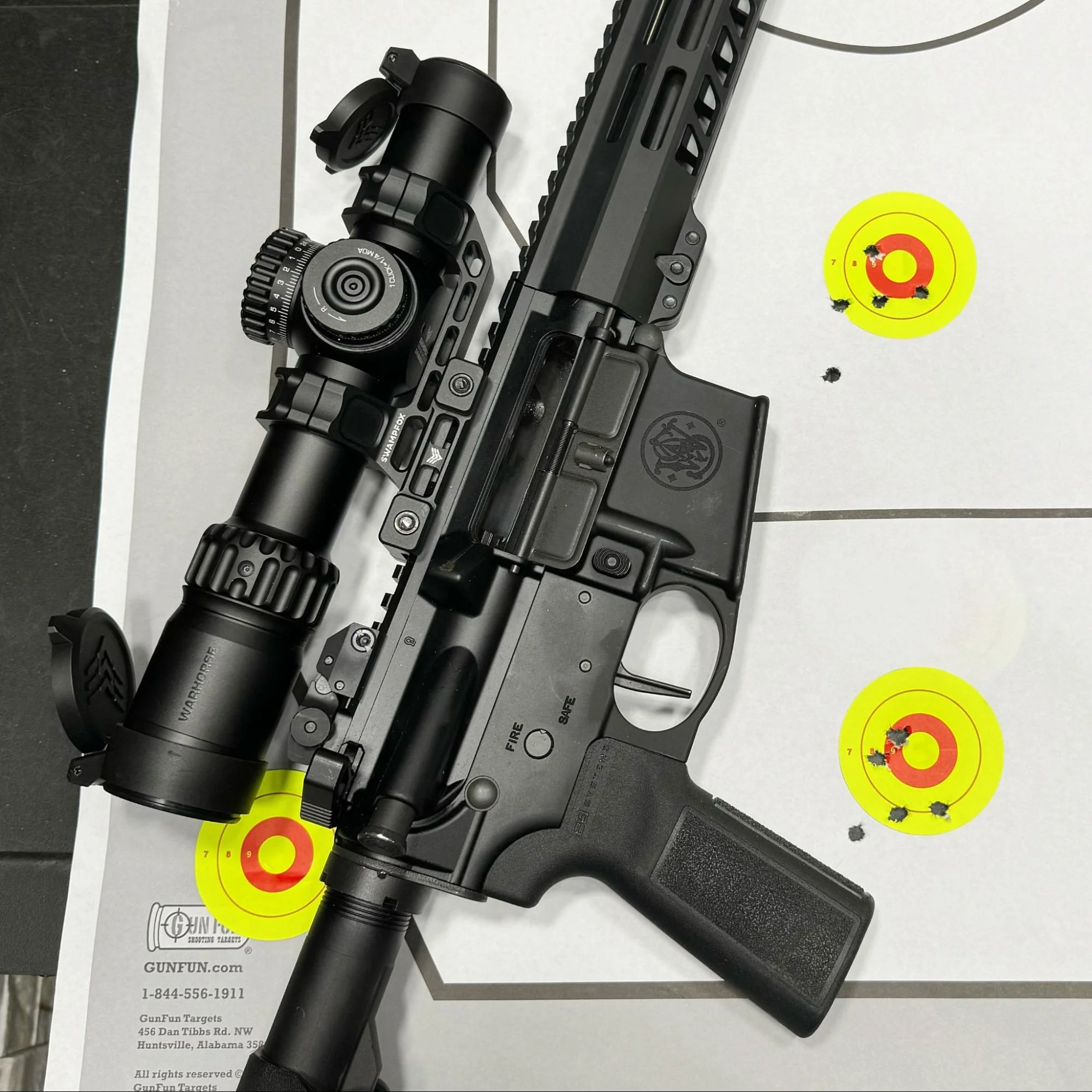 Action shot of a shooter using the Swampfox Warhorse LPVO, quickly alternating shots between two targets at a distance of 25 yards